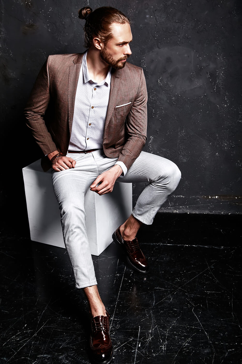 portrait-handsome-fashion-stylish-hipster-businessman-model-dressed-elegant-brown-suit-sitting-near-dark